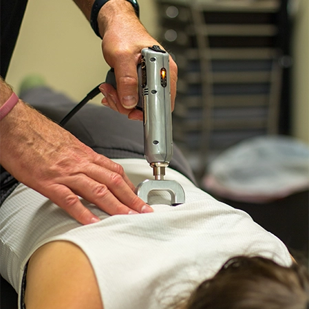 Chiropractic West Monroe LA Patient Receiving Adjustment With Device